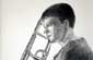 Boy holding a trombone.