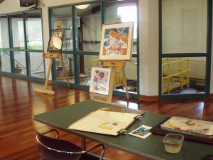 Paintings set up on easels.