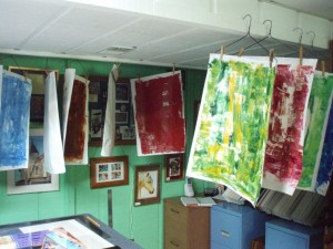 Collage papers hanging up to dry.